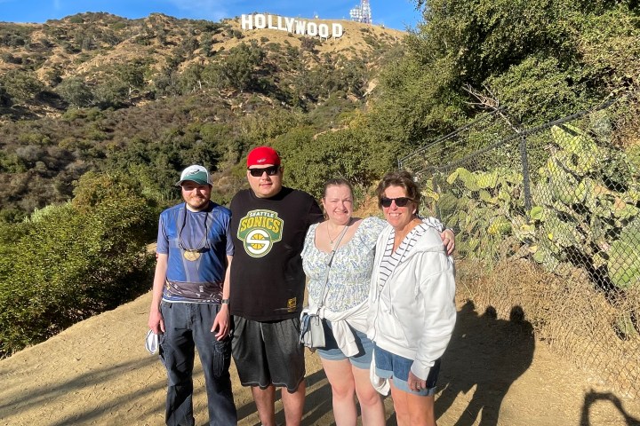 Four guests at the Hollywood Sign viewpoint on the Best of Hollywood afternoon tour