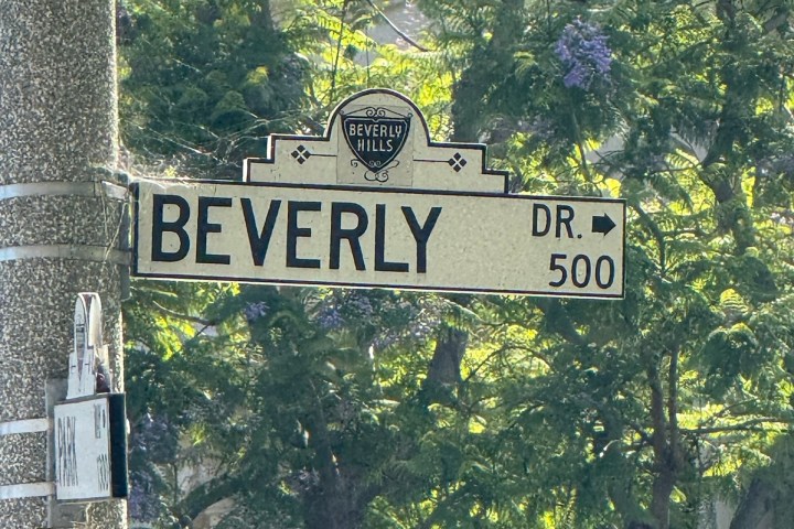 Street sign reading 'Beverly Dr 500' with trees in the background.