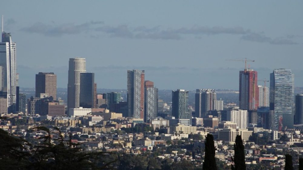 City skyline with tall buildings and clear blue sky.