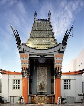 Chinese-style theater entrance with ornate roof and stone lions.