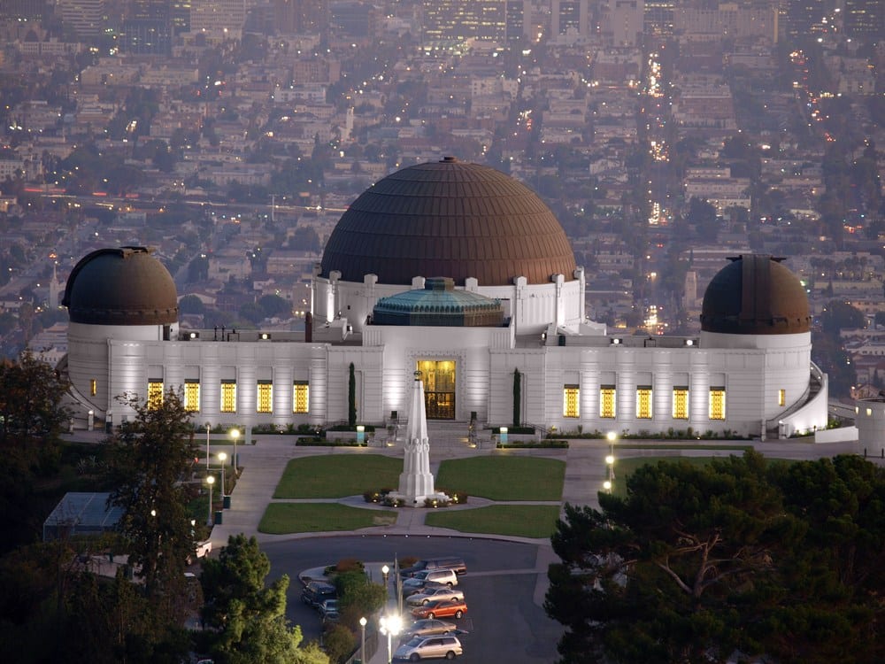 Griffith Observatory at dusk with cityscape in the background.