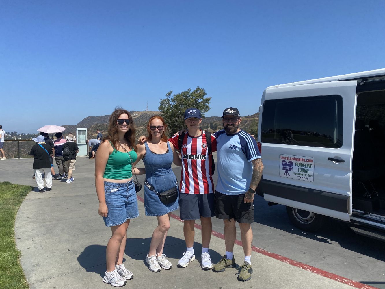Guideline Tours group from Yorkshire, England with tour guide Bing in front of the Guideline Tours van in Los Angeles