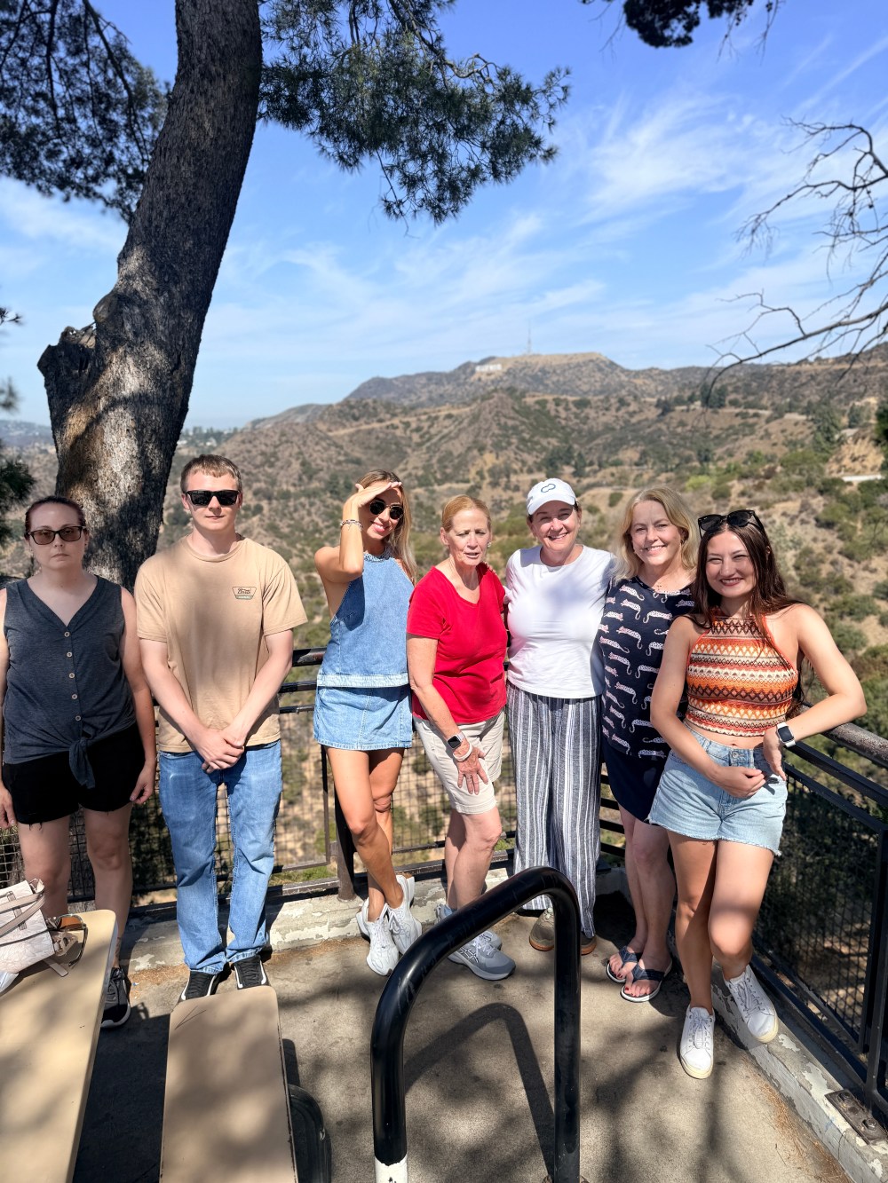 Tourists from Italy and England smiling together at Griffith Observatory overlook in Los Angeles