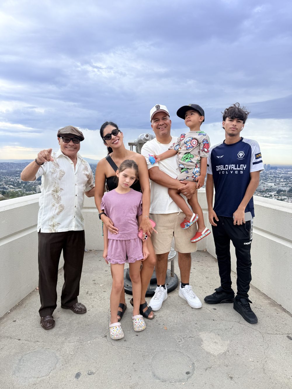 Tourist from Nicaragua with family posing near fruit vendor cart on Hollywood tour